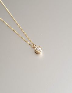 DETAILS * We never use gold plates or gold-filled metals in any of our jewelry. All the metals we use are lead-free, nickel-free, and hypoallergenic. * 0.03 ct Solitaire Pendant Width: 2.5 mm * 0.03 ct Solitaire Pendant Height: 2.5 mm * Chain Length: 18 inches * Chain Type: Dainty Cable * Clasp: Spring Ring * Ready to Ship in 1-3 Business Days * 100% US sourced * 6 Months Warranty * Free returns within 30 days from the order date DIAMOND DETAILS * Gem Stone: Genuine Diamond * Diamond-Cut: Round * Diamond Carat Weight: 0.03 CT - 0.06 CT - 0.15 CT * Diamond Color-Clarity: H Color, SI Clarity * Setting Type: Bezel Setting * 100% US sourced HANDMADE * Handcrafted by our trusted craftsmen with care. * 100% Ethically Sourced. * All processing of the packaging is done by hand.  * The Preparation Gold 14k Diamond Necklace With Single Diamond, Elegant Gold Birthstone Necklace In Recycled Gold, 14k Yellow Gold Diamond Necklace With Round Stone, Minimalist Yellow Gold Solitaire Necklace, Minimalist 14k Gold Diamond Necklace With Bezel Setting, Fine Jewelry Gold With Bezel Setting, Dainty Gold Jewelry With Bezel Setting, Gold Fine Jewelry With Bezel Setting, Timeless Gold Solitaire Necklace With Round Stone