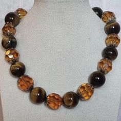 Necklace made with large tiger eye beads and faceted glass beads. The tiger eye beads are a beautiful golden brown color with a chatoyant effect, while the glass beads add sparkle and shine.  Stunning necklace in good condition Quite a heavy piece. General Info AshleyParkerVA All the items I sell have been used before and now need a new home.  They are perfect with imperfections, and I will point out the specific condition each time.  Dispatch times are 3-5 days - if you need something super qui Golden Brown Color, Statement Collar, Necklace Big, Amber Brown, Tiger Eye Beads, Eye Beads, Collar Jewelry, Tiger's Eye, Stunning Necklace