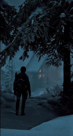 a man is walking through the snow in front of some trees and a house at night