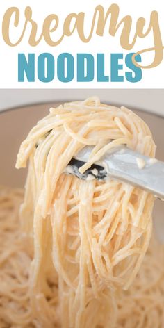 a spoon full of noodles with the words creamy noodles above it