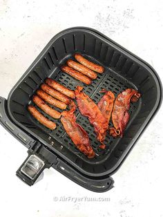 hot dogs and sausages are being cooked on the griddle in an air fryer