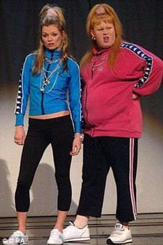 two women standing next to each other on a stage