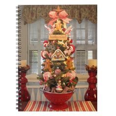 a christmas tree decorated with candy canes and gingerbread cookies in a red colander