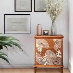 a wooden cabinet sitting next to a potted plant on top of a hard wood floor