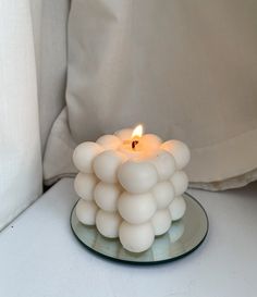 a glass plate with a lit candle in it