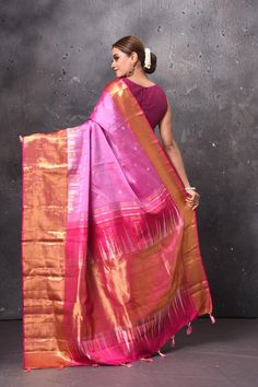 Radiate ethnic elegance on festive occasions in this rich pink handloom Kanjivaram silk . The saree is adorned with overall zari buta and golden zari border and pallu. It comes with a matching blouse piece. Shop handloom sarees in USA from Pure Elegance. Disclaimer: The shown stitched blouse on the model is for display purpose only. The saree comes with a matching blouse piece and finished with fall and piko. Pink Raw Silk Pre-draped Saree For Puja, Festive Pink Slub Silk Traditional Wear, Festive Pink Traditional Wear In Slub Silk, Pink Chanderi Pre-draped Saree For Celebration, Pink Handloom Raw Silk Pre-draped Saree, Pink Handloom Slub Silk Pre-draped Saree, Pink Paithani Silk Traditional Wear For Navratri, Pink Slub Silk Traditional Wear For Diwali, Diwali Pink Slub Silk Traditional Wear