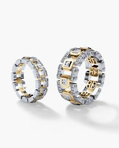 two gold and silver rings with diamonds on the inside, set against a white background