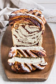 sliced cinnamon swirl bread sitting on top of a wooden plate