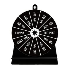 a black and white wheel of fortune with free spins on the front, as well as an arrow in the center