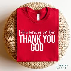 a red shirt that says, extra heavy on the thank you god