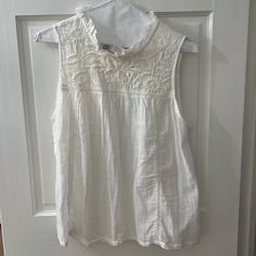 Never Worn Beautiful Embroidered White Blouse With Ruffle Collar Small Stain At Front Cotton Tops With Lace Trim Sleeveless Blouse, Casual Embroidered Sleeveless Blouse, Chic Sleeveless Embroidered Blouse, Casual Sleeveless Blouse With Lace Trim, Casual Embroidered Blouse For Daywear, White Casual Embroidered Lace Top, White Sleeveless Blouse With Floral Embroidery, Casual Sleeveless Blouse With Floral Embroidery, Embroidered Sleeveless Blouse For Spring