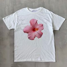 Hibiscus Classic Unisex Tee Hibiscus Classic Unisex Tee, Heavy Cotton Graphic T-Shirt, Iconic Slogan Print - 100% cotton - Classic Unisex fit - Runs true to size (refer to size chart) - Tear-away label - Y2K Vintage Streetwear Trending Fashion - Environmentally sustainable made-to-order system Please refer to the size chart in the listing photos for more sizing details. Don't forget to tag us in any photos or videos :) White Hibiscus Print T-shirt For Spring, Casual Hibiscus Print Tops With Relaxed Fit, Casual Relaxed Fit Tops With Hibiscus Print, Pink Hawaiian Short Sleeve T-shirt, Hawaiian Cotton Floral Print Tops, White Cotton Top With Hibiscus Print, Pink Hibiscus Print T-shirt For Summer, Hawaiian Cotton Tops With Print, Hawaiian Cotton Printed Tops