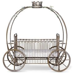 an old fashioned metal baby crib on wheels