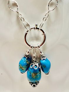 Three Sleeping Beauty Turquoise stones dangling from a 20 mm spring ring Sterling Silver clasp along with a fancy long and short oval sterling silver chain. Elegant Turquoise Necklace With Lobster Clasp, Sterling Silver Turquoise Jewelry With Lobster Clasp, Elegant Sterling Silver Turquoise Dangle Necklace, Turquoise Teardrop Jewelry With Lobster Clasp, Elegant Blue Turquoise Necklace With Lobster Clasp, Elegant Blue Turquoise Necklace, Sterling Silver Turquoise Necklace With Adjustable Chain, Sleeping Beauty Turquoise, Turquoise Stones