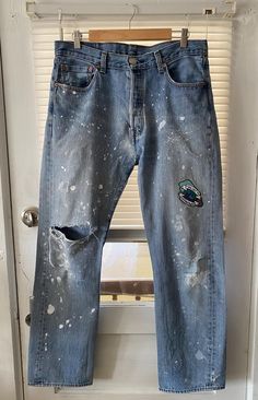 Recently rescued these well worn buttonfly jeans. They already had the perfectly distressed thing going on so I splattered them with some white fabric paint and found THE PERFECT patch to add. A pigeon that says 'I will sh*t on everything you love' is the perfect way to finish off these one of one jeans.  These have been washed and then heat set with a professional heat press, so they are ready to go! I'd still recommend washing them inside out, just to extend the life of the jeans, but most jeans should be washed that way to preserve the wash :) Approximate Measurements: are 16.5" across the waist and 29.5" for the inseam. Size on Tag reads 34x32 and the buttons work great. If you have any questions, please feel free to send me a message! Thank you :) Jeans With Paint Splatters, Paint Splatter Pants, Jeans With Paint, Paint Splatter Jeans, Patch Pants, Custom Jeans, One Of One, Painted Jeans, Distressed Painting