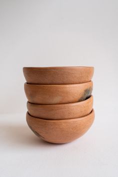 four wooden bowls stacked on top of each other