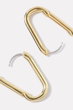 two pairs of gold - plated metal hoop earrings on a white background, one is open and the other has a hook