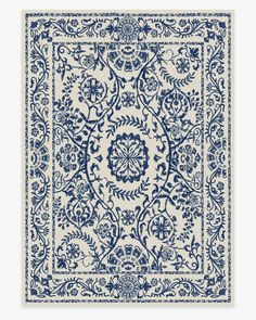 a blue and white rug with an intricate design on the bottom, in front of a white background