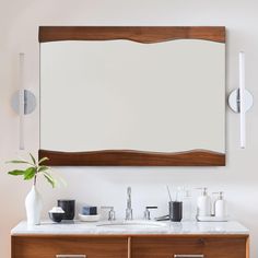 a bathroom vanity with a large mirror above it