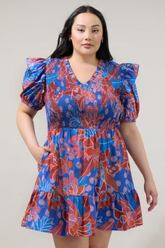 You'll always be dressed and ready for fun adventures in the Amazonia Blue Leones Smocked Mini Dress! Features a Ruffle trim V neckline and fully smocked bodice framed by short puff sleeves. It tops a flared ruffle tier mini skirt. Wear it with red heels to match this gorgoues mini dress!- Breathable- Smocked bodice- Ruffle details- Pockets- Color: Blue RedSize + Fit - Model is 5'10" and wearing size 2X- Measurements taken from size 2X- Chest: 21 1/4"- Length: 39 1/2" Fabric Self:100%Cotton Styl Beach Dresses With Smocked Cuffs And V-neck, Blue V-neck Dress With Smocked Bodice, Vacation Smocked V-neck Dress With Smocked Cuffs, Vacation V-neck Smocked Dress With Smocked Cuffs, Blue V-neck Smocked Dress For Spring, V-neck Smocked Dress With Smocked Cuffs For Vacation, Spring V-neck Blue Smocked Dress, Spring Blue V-neck Smocked Dress, Blue V-neck Smocked Dress