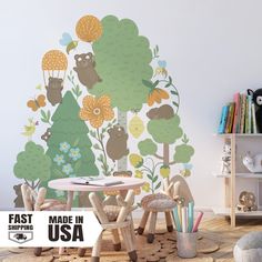 a children's room with an animal themed wall decal and playroom furniture