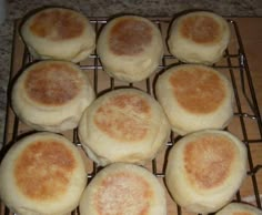 several round breads are cooling on a wire rack