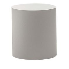 a white vase sitting on top of a table