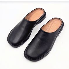 Materials: 100% Genuine Leather Sole: Comfort-contoured Heel: Flat Fit: Snug  Size Chart: For sizing information, please see the size chart included in the picture gallery or use online shoes size converter https://www.gigacalculator.com/converters/shoe-size-converter.php Elevate your style with these sleek Leather Mules for Women: Flat Shoes for Women, Gift for Women  The modern square-toe design adds a touch of sophistication, while the smooth leather construction ensures comfort and quality. Black Closed Toe Slip-ons With Leather Footbed, Leather Slip-ons With Square Toe And Rubber Sole, Black Slip-ons With Leather Footbed, Black Leather Slip-on Mules, Black Leather Slip-ons For Spring, Black Almond Toe Clogs For Formal Occasions, Formal Black Almond Toe Clogs, Casual Slip-on Mules With Square Toe, Black Clogs With Leather Footbed For Work