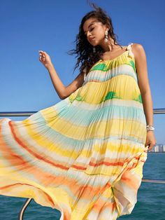 Make your vacation style stand out with the Isabella Women's Colorful Striped & Printed Shoulder Tassel & Fringe Dress. Rendered in a vibrant yellow with playful tie-dye stripes, it captures the easy-going vibe of leisure time. Featuring a cami cut with spaghetti straps, it's designed to keep you cool. The ruffle hem, combined with a layered/tiered flounce shape, adds an extra dose of whimsy. A knot detail at the waist accentuates your figure while contributing to the visual interest. Made from a non-stretch fabric, this oversized sleeveless dress ensures comfort and an easy breezy fit. Be it a beach trip or a day out in the city, this long dress promises to add a pop of color to your look. SIZE + FIT Model is Wearing: S (UK8) Height: 176.0 / 69.3 Bust: 83.5 / 32.9 Waist: 64.0 / 25.2 Hips: فستان زهري, Dress For Vacation, Floral Wedding Dress, Fringe Dress, Leisure Time, Easy Breezy, Vacation Style, Tassel Fringe, Easy Going