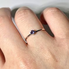 Iolite is a stunning gemstone because it's pleochroic, meaning you can see three distinct colors in three crystal directions. The rich violet-blue hues of iolite really stand out in this dainty solitaire so much so that you'll love to wear this ring everyday. 925 sterling silver 1 - 3mm round brilliant iolite Castle setting 1.2mm half round ring band 100% handcrafted Made in the US Ethically sourced materials Ring Band Size 1.2 mm Carat 0.17 Cut Round Brilliant Grade AAA Purple Tanzanite Sapphire Ring As A Gift, Gift Sapphire Ring With Tanzanite Birthstone, Ethical Tanzanite Birthstone Ring, Blue Amethyst Birthstone Ring Gift, Tanzanite Amethyst Birthstone Ring As Gift, Purple Sapphire Birthstone Ring For Promise, Tanzanite Birthstone Ring With Prong Setting Gift, Tanzanite Solitaire Birthstone Ring As Gift, Round Tanzanite Solitaire Birthstone Ring