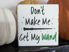 a sign that says don't make me get my wand on it next to pumpkins