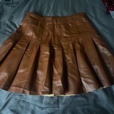 I Brought The Skirt But Was Never Able To Wear It Because The Waist Line Is Small Although I Wear A Size Small So Originally This Is A Woman’s Skirt But Because It Fits So Small A Child Can Fit This. Removed The Tag Because I Thought I Would Be Able To Wear It But It Is Brand New Never Worn. Brown Pleated Mini Skirt For Fall, Trendy Pleated Brown Mini Skirt, Fall Brown Pleated Mini Skirt, Trendy Brown Pleated Mini Skirt, Trendy Faux Leather Skort For Fall, Trendy Brown Faux Leather Mini Skirt, Pleated Faux Leather Mini Skirt For Parties, Trendy Fitted Brown Pleated Skirt, Trendy Pleated Brown Bottoms