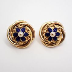 Vintage 16k (.667) yellow gold ornate round form earrings, having dark blue enamel flower centerpiece, accented with Seed Pearl. The backs are 14k (.585) yellow gold (replaced), the earrings were tested to be 16k gold. These majestic earrings are 25 mm in diameter, weighing a total 15.4 grams. EA3502 Elegant Enamel Flower Shaped Jewelry, Blue Flower Shaped Earrings For Formal Occasions, Blue Flower-shaped Formal Earrings, Blue Formal Flower-shaped Earrings, Formal Blue Flower-shaped Earrings, Elegant Enamel Flower Earrings For Wedding, Elegant Enamel Flower Earrings, Formal Flower-shaped Clip-on Jewelry, Formal Clip-on Flower Earrings