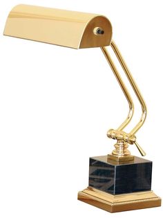 a gold desk lamp with a black base