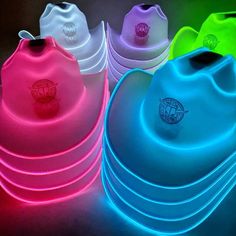 neon colored frisbees are lined up in a row