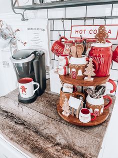 a stack of coffee mugs sitting on top of a wooden table next to a stove