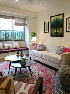 a living room with two couches, a coffee table and pictures on the wall