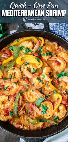 a skillet filled with cooked shrimp and peppers on top of a wooden table next to a