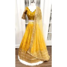 Title: "Elegant Shimmery Sequin Lehenga Choli - Size 42 - Heavy Partywear Dress for Haldi - Scallop Design Blouse - Stitched" Description: Elevate your haldi ceremony with our exquisite Shimmery Sequin Lehenga Choli. Crafted with meticulous attention to detail, this stunning ensemble is perfect for making a statement on your special day. The lehenga features intricate sequence work that shimmers and shines with every move, while the scallop design blouse adds a touch of elegance. Stitched to per Fitted Traditional Lehenga In Georgette, Traditional Fitted Georgette Lehenga, Fitted Traditional Lehenga With Resham Embroidery, Floor-length Fitted Choli With Resham Embroidery, Fitted Sharara With Resham Embroidery For Transitional Season, Bollywood Style Fitted Choli For Festive Occasions, Bollywood Style Fitted Choli For Eid, Fitted Sharara With Unstitched Blouse For Eid, Elegant Yellow Lehenga