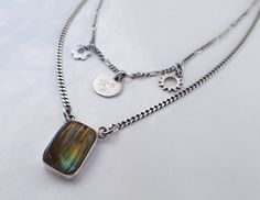 "Two layer sterling silver necklace with gorgeous labradorite focal piece and delicate sun, flower and stars charms. Choose your length:  (measured from shortest layer) 16, 17, 18, 20, 22, 24 inches.   The beautifully set rectangle labradorite cabochon, 15 x 11 x 3.5 mm (about 5/8 inches long), is thick, with an excellent quality labradorite (see gemstone details below), and with two loops at each side of the top. The two tiny side charms are similar - flower and sun with open center, and a bail Celestial Silver Labradorite Necklace, Kailua Kona, Necklace Flower, Labradorite Cabochon, Cool Necklaces, Multi Strand Necklace, Star Charms, Etsy Shipping, Strand Necklace