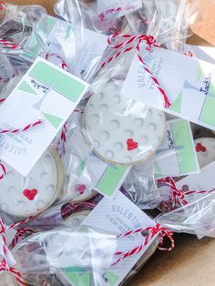 some cookies are wrapped in plastic and tied with red twine string to give them as favors