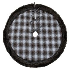 a black and white checkered rug with a button on the center, hanging from a hook