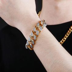 Extra bling for your wrist! The 18MM Cuban Link Bracelet is the perfect accessory to take your style up a notch. With its glittering cubic zirconia stones set in gold-plated metal, this bracelet adds a touch of luxury to any outfit. Whether you're dressing up for a special occasion or just looking to add a little sparkle to your everyday look, this bracelet is sure to turn heads. At an unbeatable price, there's no reason not to indulge in a little extra bling. So don't wait any longer, order you Gold Iced Out Tennis Bracelet, Adjustable Gold Iced Out Bracelets, Gold Iced Out Bracelets As Gift, Gold Iced Out Jewelry For Party, Gold Metal Crystal Bracelet With Bling, Gold Rhinestone Bangle Jewelry, Gold Metal Bracelets With Rhinestones, Adjustable Gold Bracelet With Rhinestones, Gold Diamond Bracelets For Party