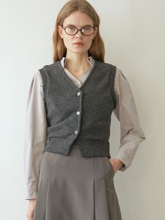 Slim-fit rib-knit wool blend sweater vest. V-neck and buttons at front. Ribbing at neckline, armholes, and hem.- Regular length- Slim fit- V-neck V-neck Knit Vest For Work, Gray V-neck Vest For Workwear, Fall Business Casual Vest With Buttons, Classic V-neck Sweater Vest For Winter, Gray V-neck Sweater Vest For Layering, V-neck Sweater With Buttons For Work, Elegant Winter Workwear Sweater Vest, Gray Sweater Vest For Fall, Fall Workwear Cardigan Vest