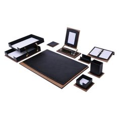 an assortment of black and gold desk accessories