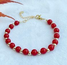 This beautiful and simple design coral red bracelet is made with 6cm bright red carol beads,  4cm 14k gold plated, and 18k gold extension. Length: 16cm with 5 cm extension.  This bracelet is ready and can be posted in 1 working day by royal mail 2nd class. It will be packed with a gift box and ready to be gifted.  More can be found:  http://www.etsy.com/uk/shop/smartsmalldesigns Red Bracelet, Red Bracelets, Coral Red, Gift Christmas, Bright Red, Arm Band, Royal Mail, Uk Shop, Simple Design