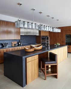 a kitchen with wooden cabinets and black counter tops is shown on the instagram page