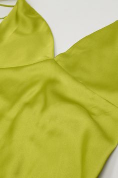 Turn heads with our Satin Maxi Dress With Spaghetti Straps in Lime Green. This lovely slip dress, made from a blend of 95% polyester and 5% elastane, offers a beautiful satin finish that adds a touch of luxury to any occasion. Designed with a V-neck neckline and spaghetti straps, this dress features an elegant A-line cut that flatters your figure. The open back and zip-back fastening add a hint of allure, making it perfect for parties and special events. The maxi length and sleeveless style ensure a comfortable and stylish fit. Key Features: Material: 95% Polyester, 5% Elastane Fit: Runs true to size, regular fit Details: Maxi length, V-neck neckline, spaghetti straps, open back, zip-back fastening, satin finish Model Info: Wearing size S. Measurements - Bust: 33", Waist: 24", Hips: 35", H Sleeveless Solid Satin Dress, Solid Satin Summer Dress, Spring Green Halter Neck Slip Dress, Satin Bridesmaid Dress With Spaghetti Straps, Elegant Green V-neck Camisole, Summer Satin Halter Neck Slip Dress, Solid Sleeveless Bias Cut Satin Dress, Sleeveless Solid Satin Dress With Bias Cut, Solid Sleeveless Bias-cut Satin Dress