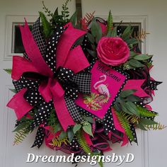 a pink and black wreath with a flamingo on it