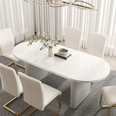 a white dining table surrounded by chairs and a vase with flowers